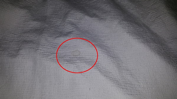 Dirty stain on bed cover